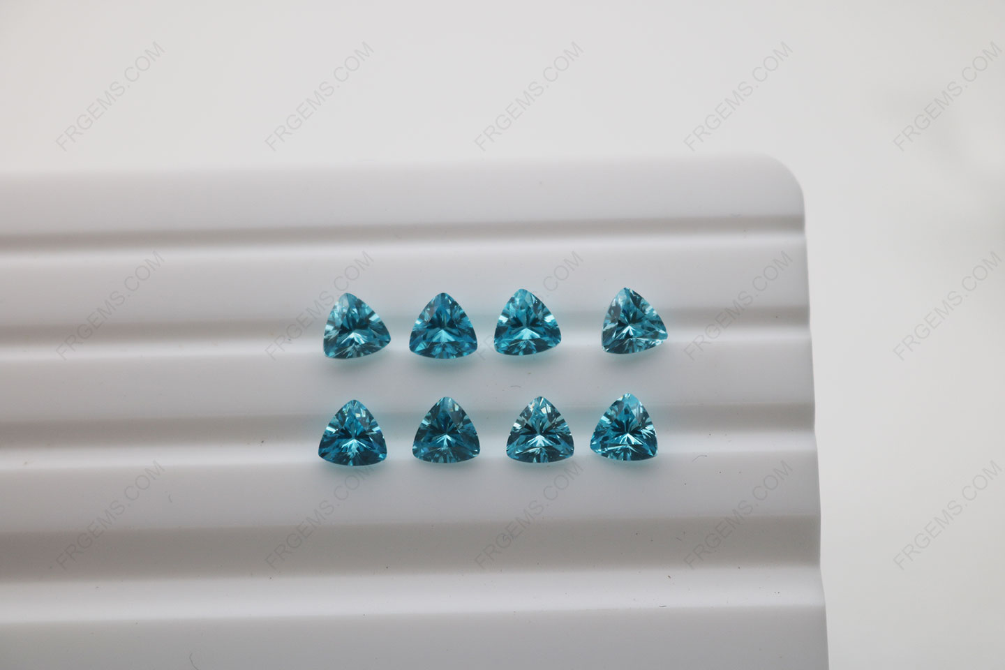 Cubic_Zirconia_Aquamarine_Trillion_Shape_Diamond_faceted_cut_5x5mm_stones_IMG_4893